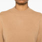 Beige sweater with 'A.P.C.' branding on a white background