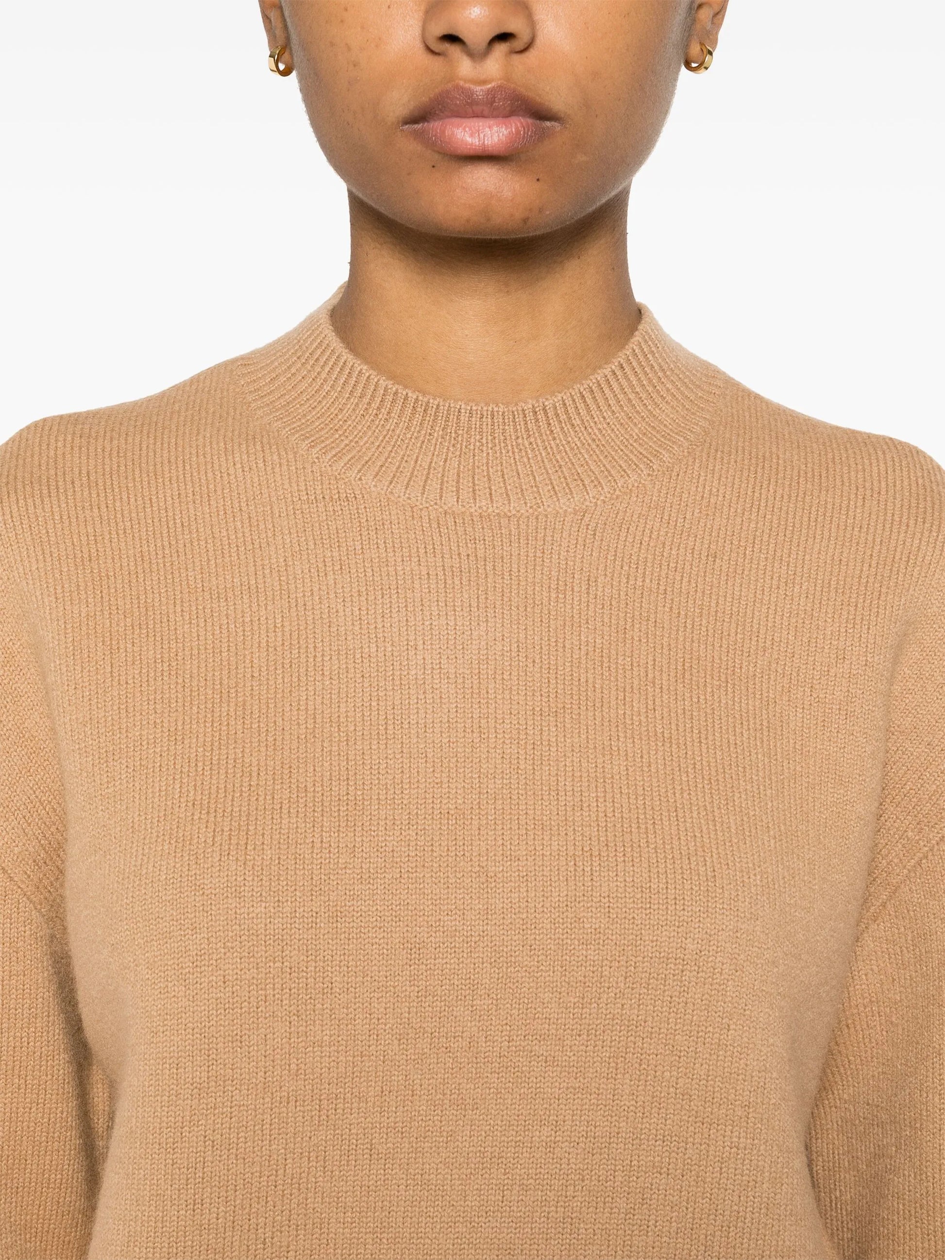 Beige sweater with 'A.P.C.' branding on a white background