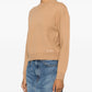 Beige sweater with 'A.P.C.' branding on a white background
