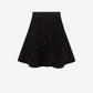 Black skirt with white polka dots on a white background