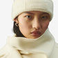 Beige knit sweater with 'Jacquemus' branding on a light background