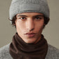 Gray knit beanie with a patch on a white background