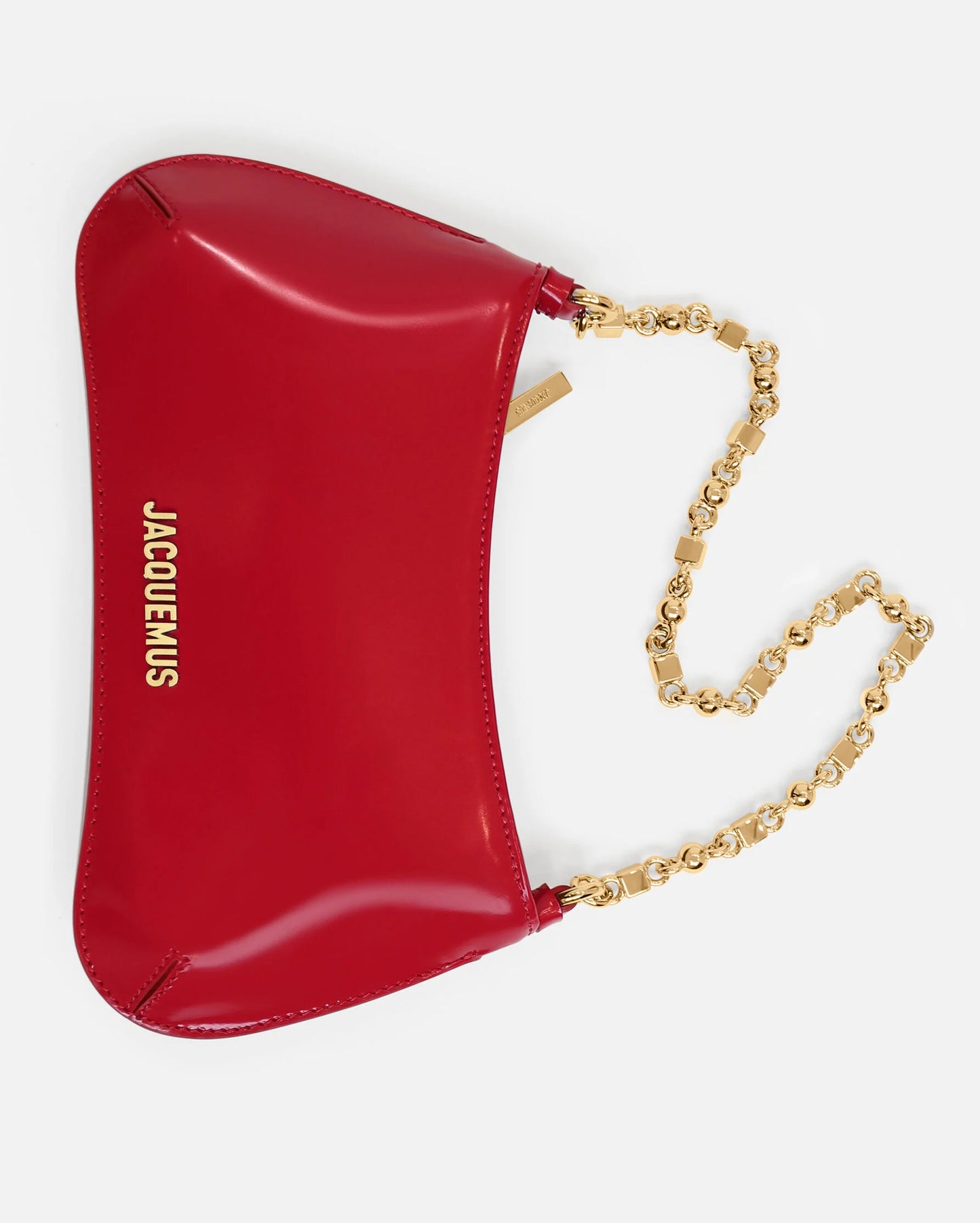 Red handbag with gold chain strap on a white background