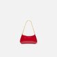 Red handbag with gold chain strap on a white background
