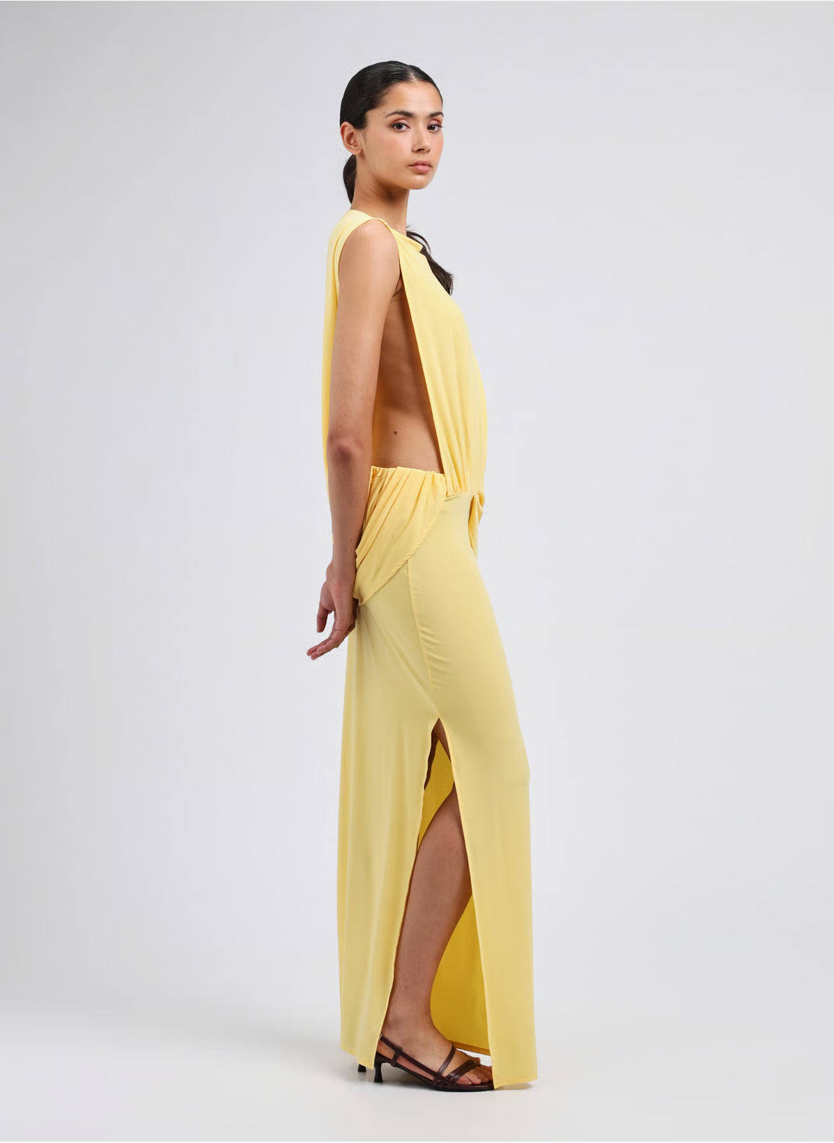 Yellow strapless dress on a light gray background