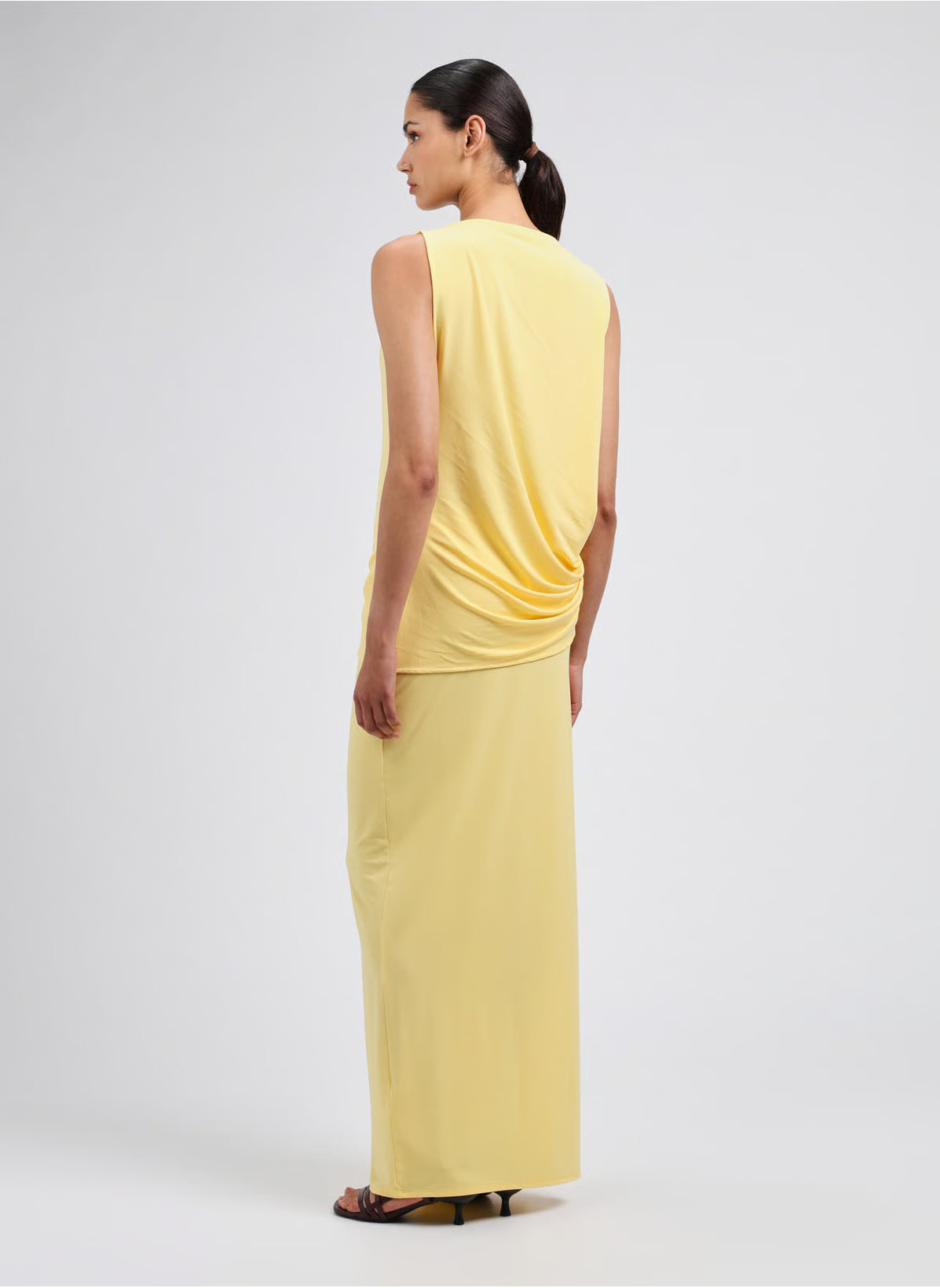 Yellow strapless dress on a light gray background