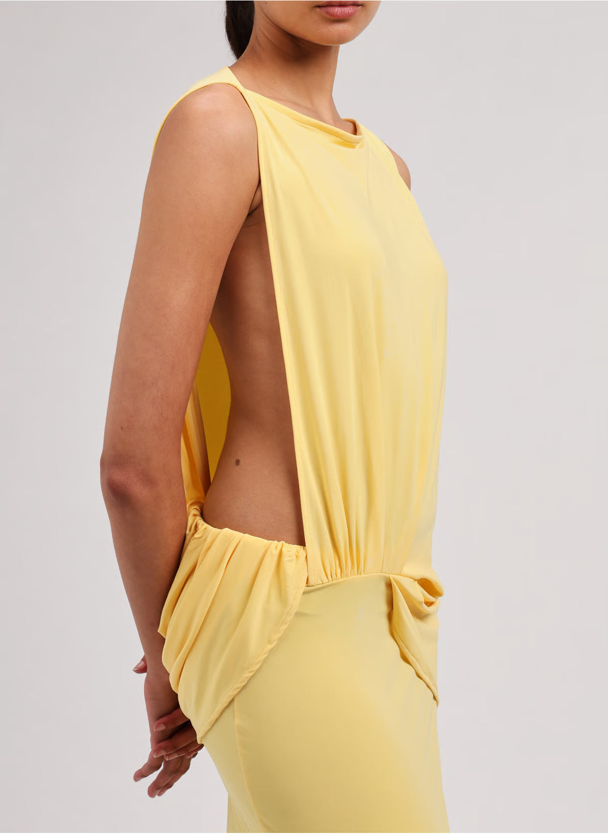 Yellow strapless dress on a light gray background