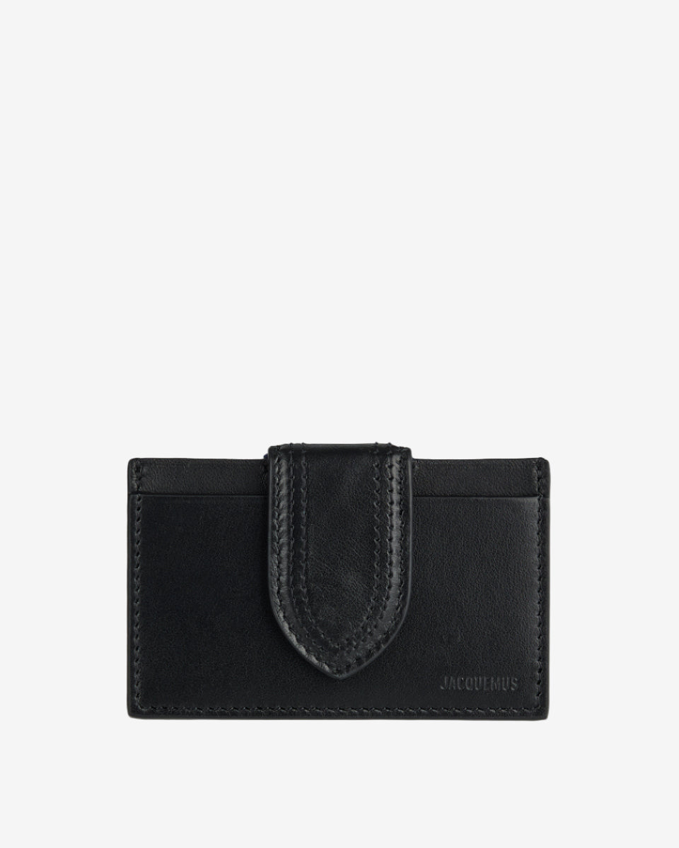 Black leather wallet with a unique strap design on a white background