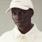 Beige cap with 'JACQUEMUS' branding on a white background