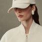Beige cap with 'JACQUEMUS' branding on a white background