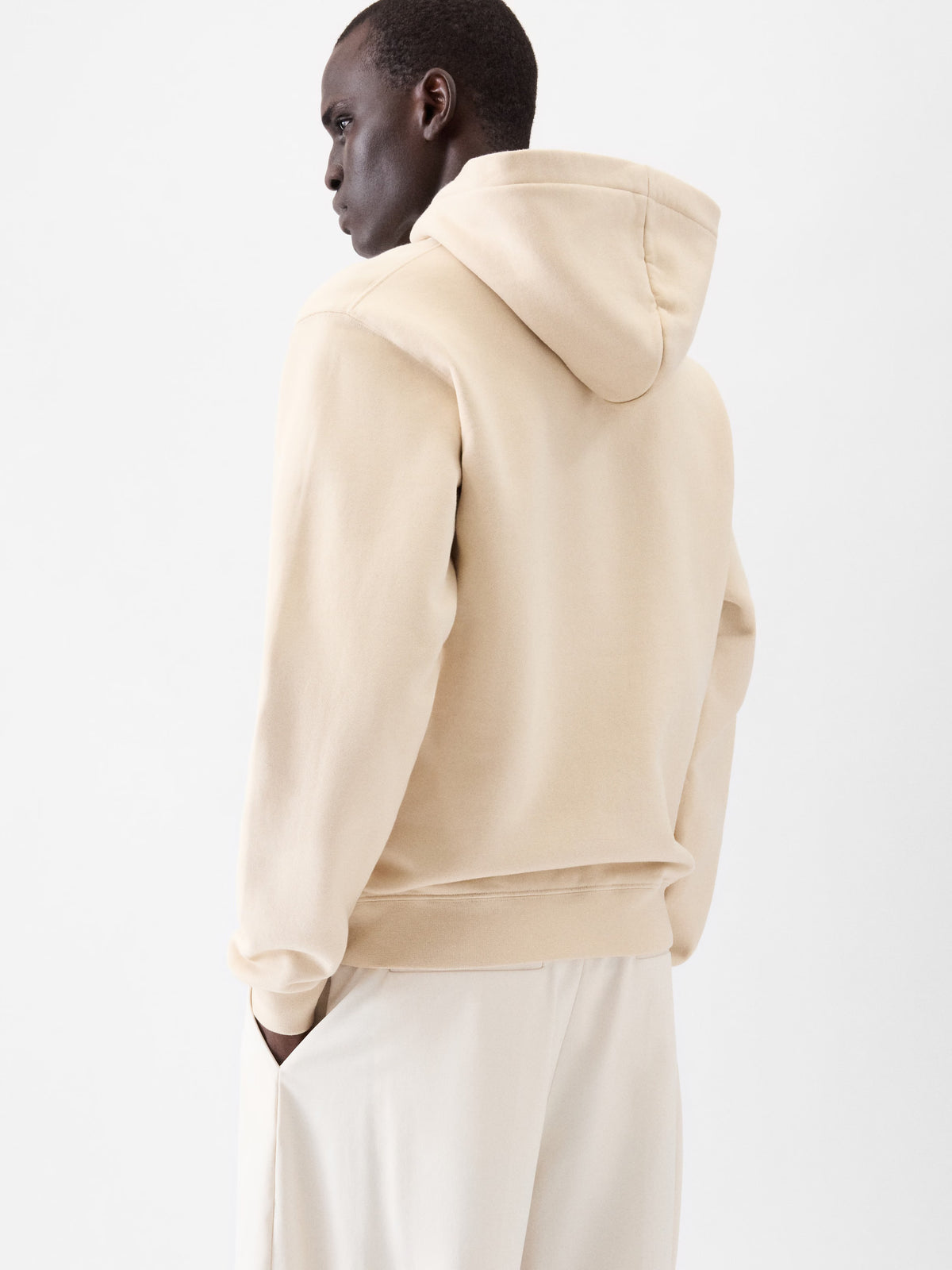Beige hoodie with a brand logo on a white background