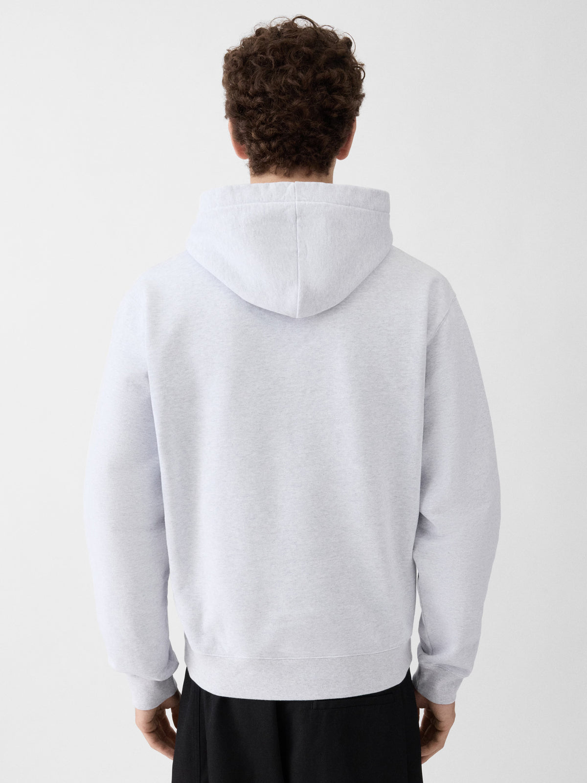 Grey hoodie with a small logo on the chest against a white background