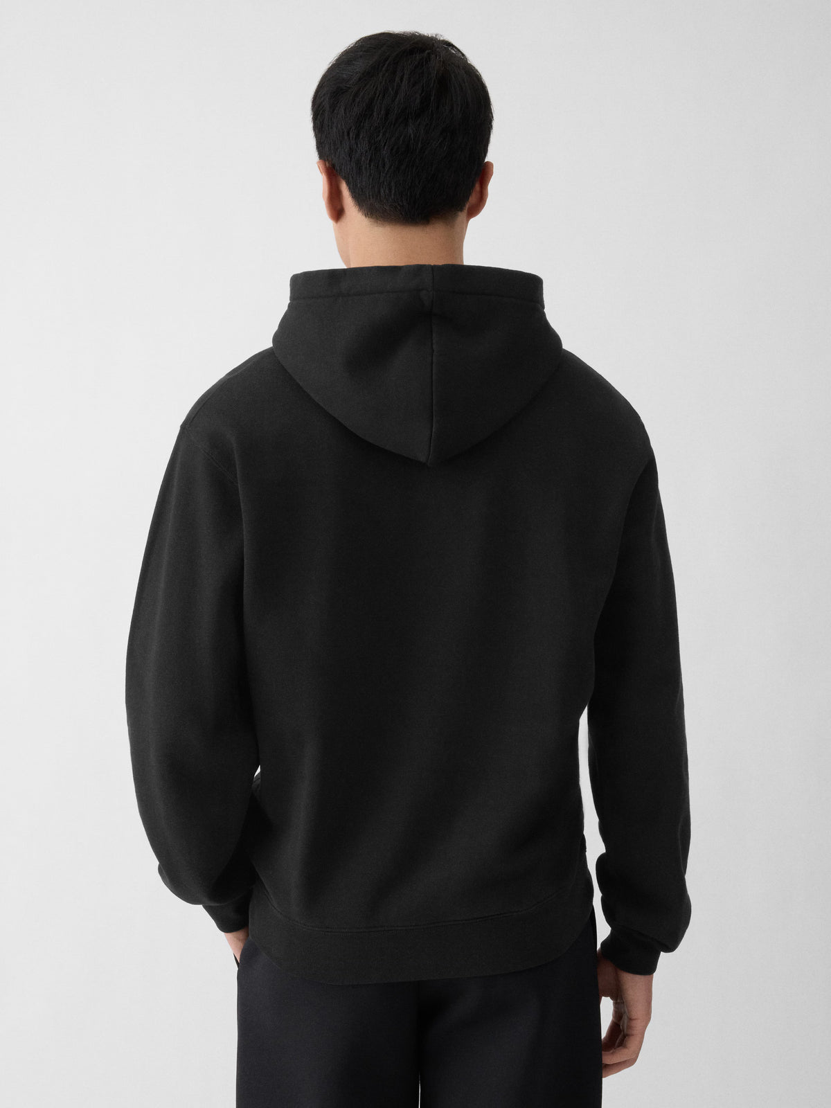 Black hoodie with a small logo on the chest against a white background