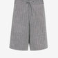 Gray shorts with a tie waist on a light gray background