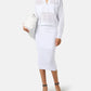Woman wearing a white outfit with sunglasses on a plain background