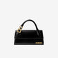 Black handbag with gold accents on a white background