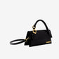 Black handbag with gold accents on a white background