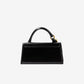Black handbag with gold accents on a white background