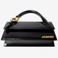 Black handbag with gold accents on a white background
