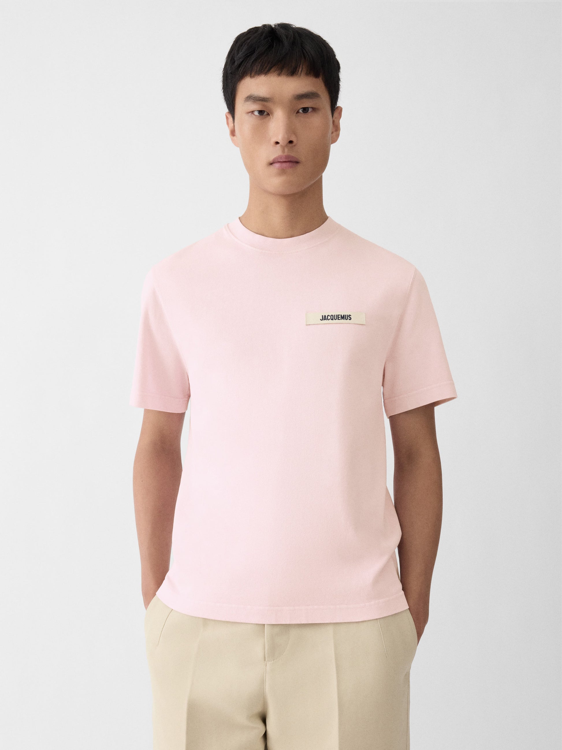 Light pink t-shirt with a small logo on a white background