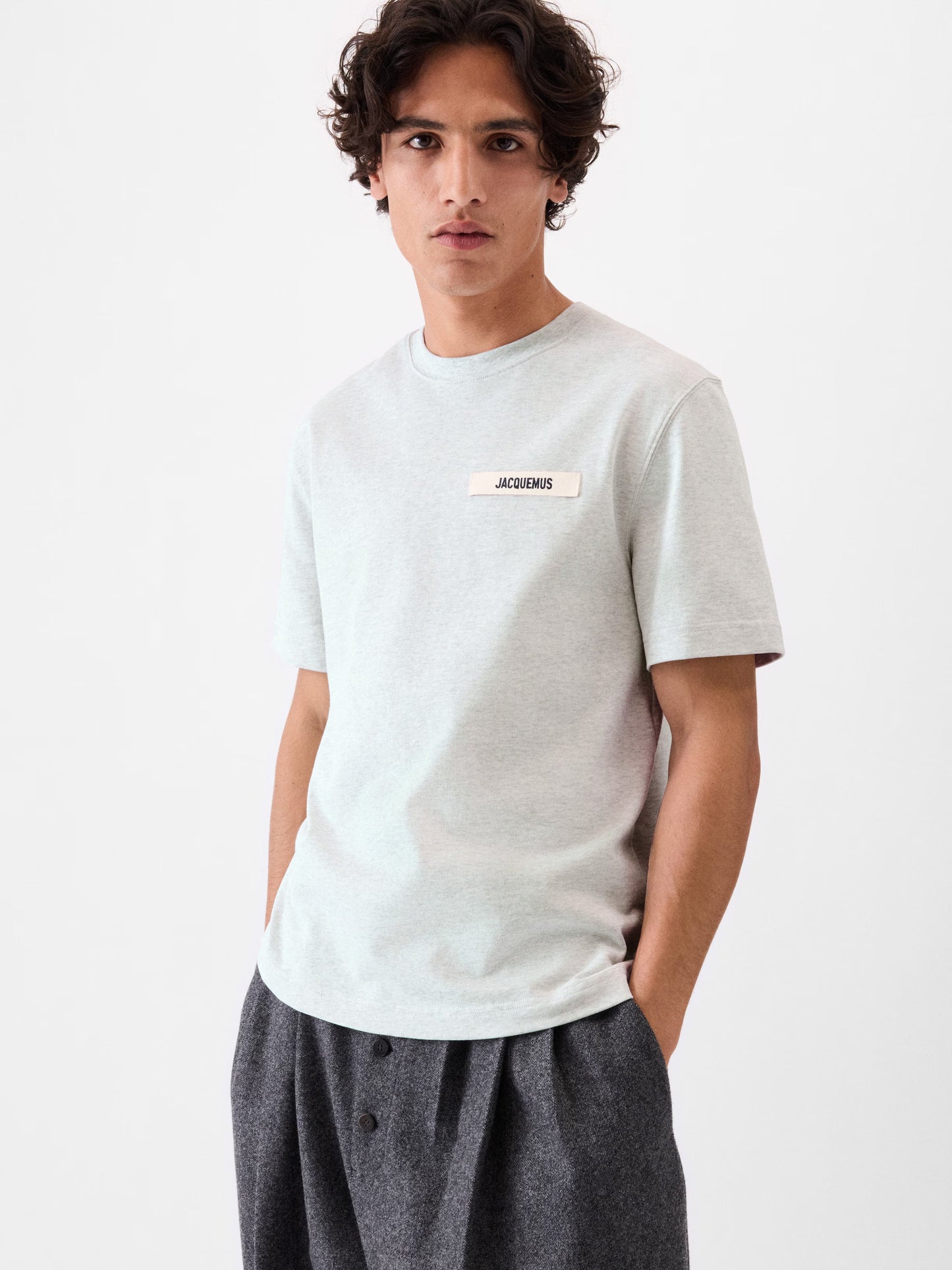 grey t-shirt with a small logo on a white background