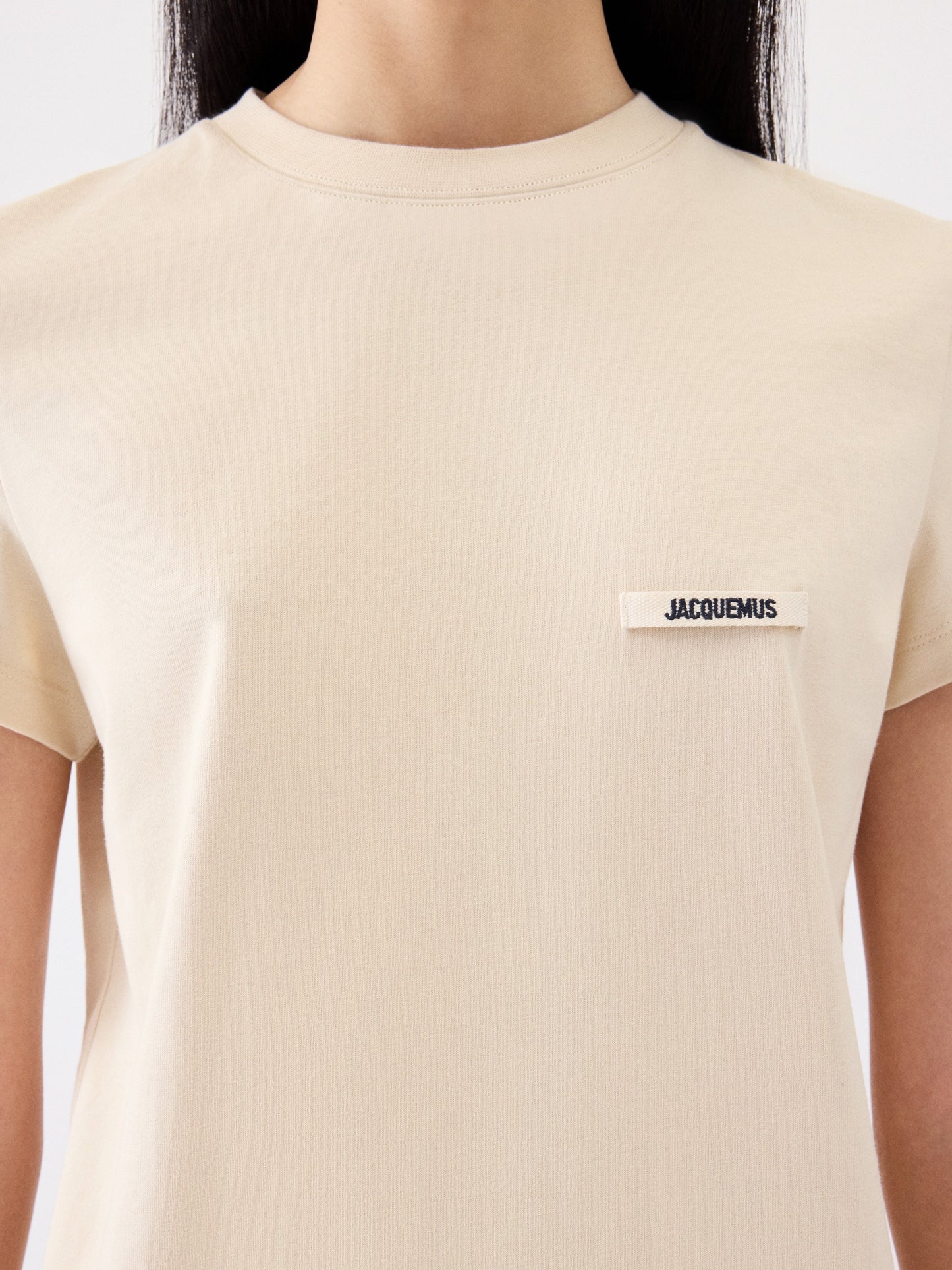beige t-shirt with a small logo on a white background JACQUEMUS