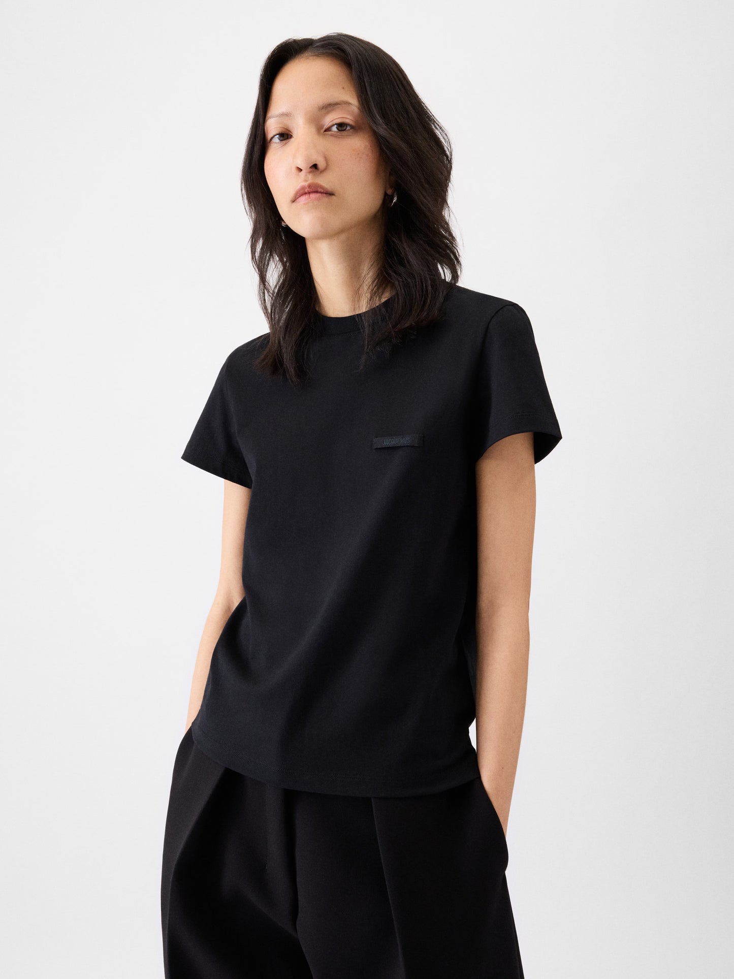 black t-shirt with a small logo on a white background JACQUEMUS