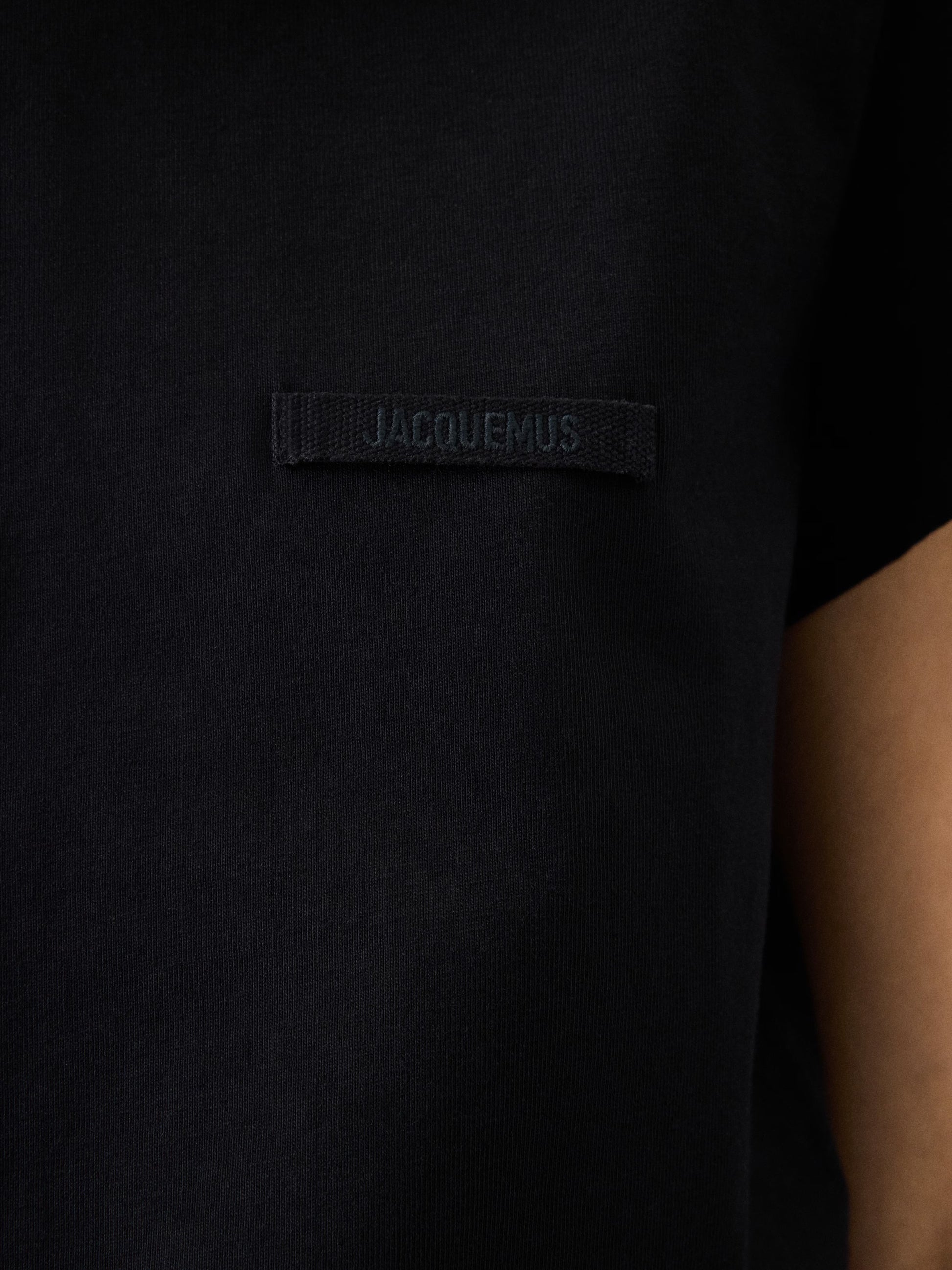 black t-shirt with a small logo on a white background JACQUEMUS