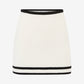 White skirt with black trim on a white background