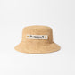 Beige bucket hat with 'Jacquemus' label on a white background