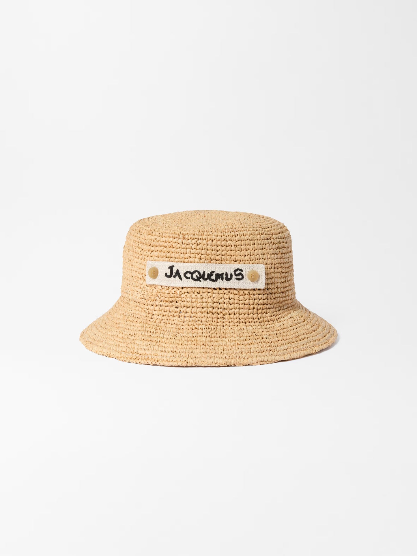 Beige bucket hat with 'Jacquemus' label on a white background