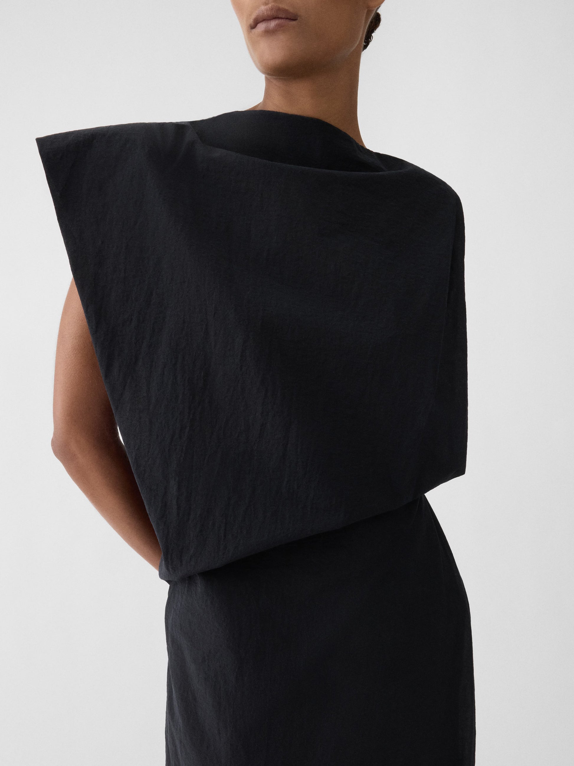 Black one-shoulder dress on a white background JACQUEMUS