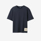 Navy t-shirt with a beige label on a light gray background JACQUEMUS