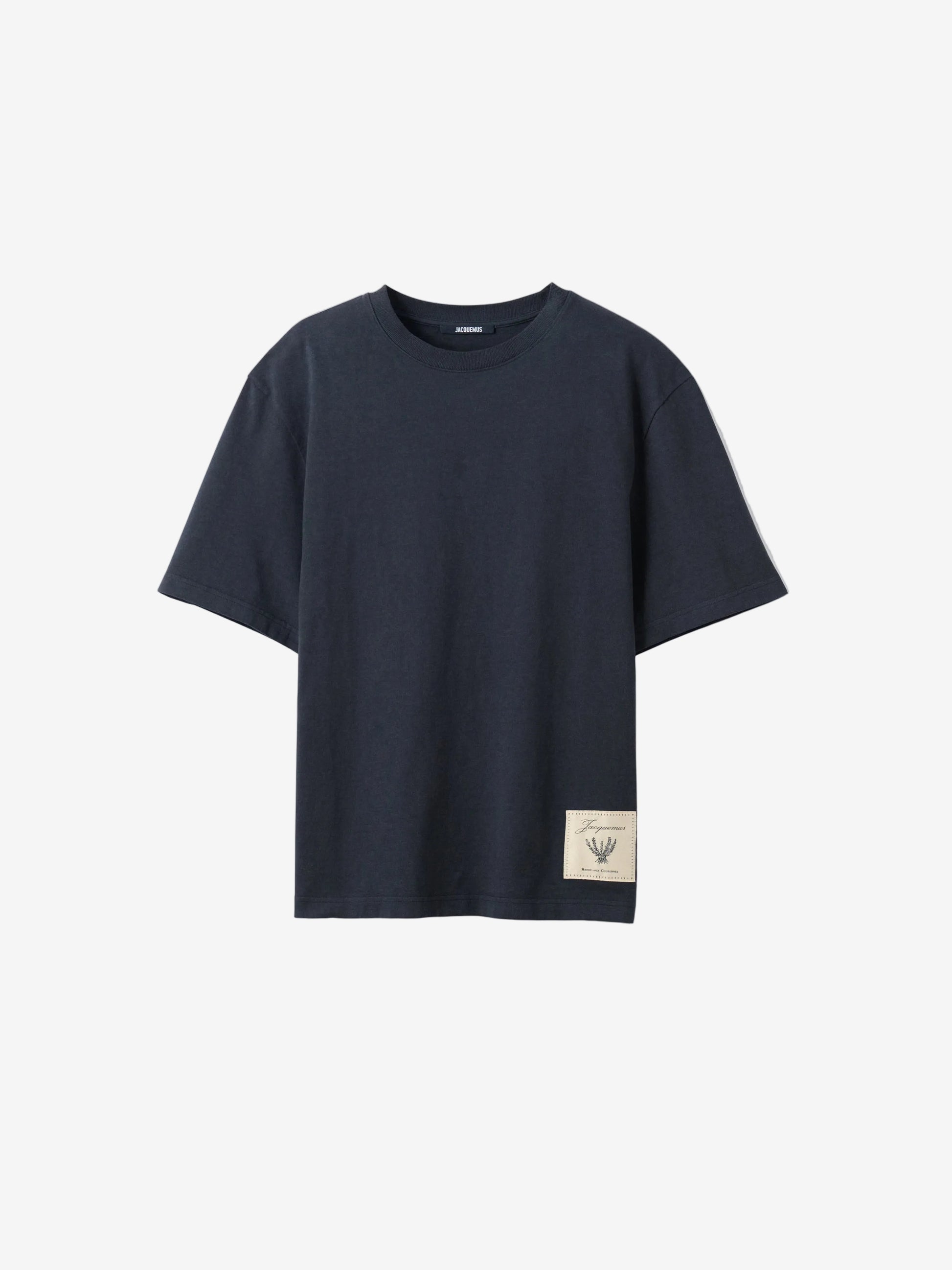 Navy t-shirt with a beige label on a light gray background JACQUEMUS