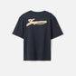 Navy t-shirt with a beige label on a light gray background JACQUEMUS
