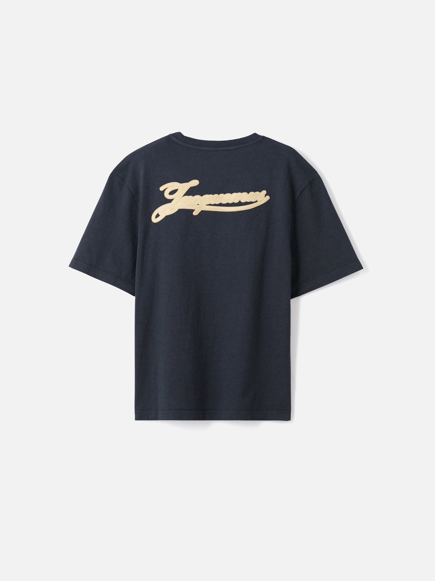 Navy t-shirt with a beige label on a light gray background JACQUEMUS