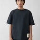 Navy t-shirt with a beige label on a light gray background JACQUEMUS