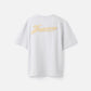 Grey t-shirt with a beige label on a light gray background JACQUEMUS
