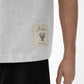 Grey t-shirt with a beige label on a light gray background JACQUEMUS