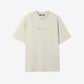 Beige t-shirt with a small logo on a white background