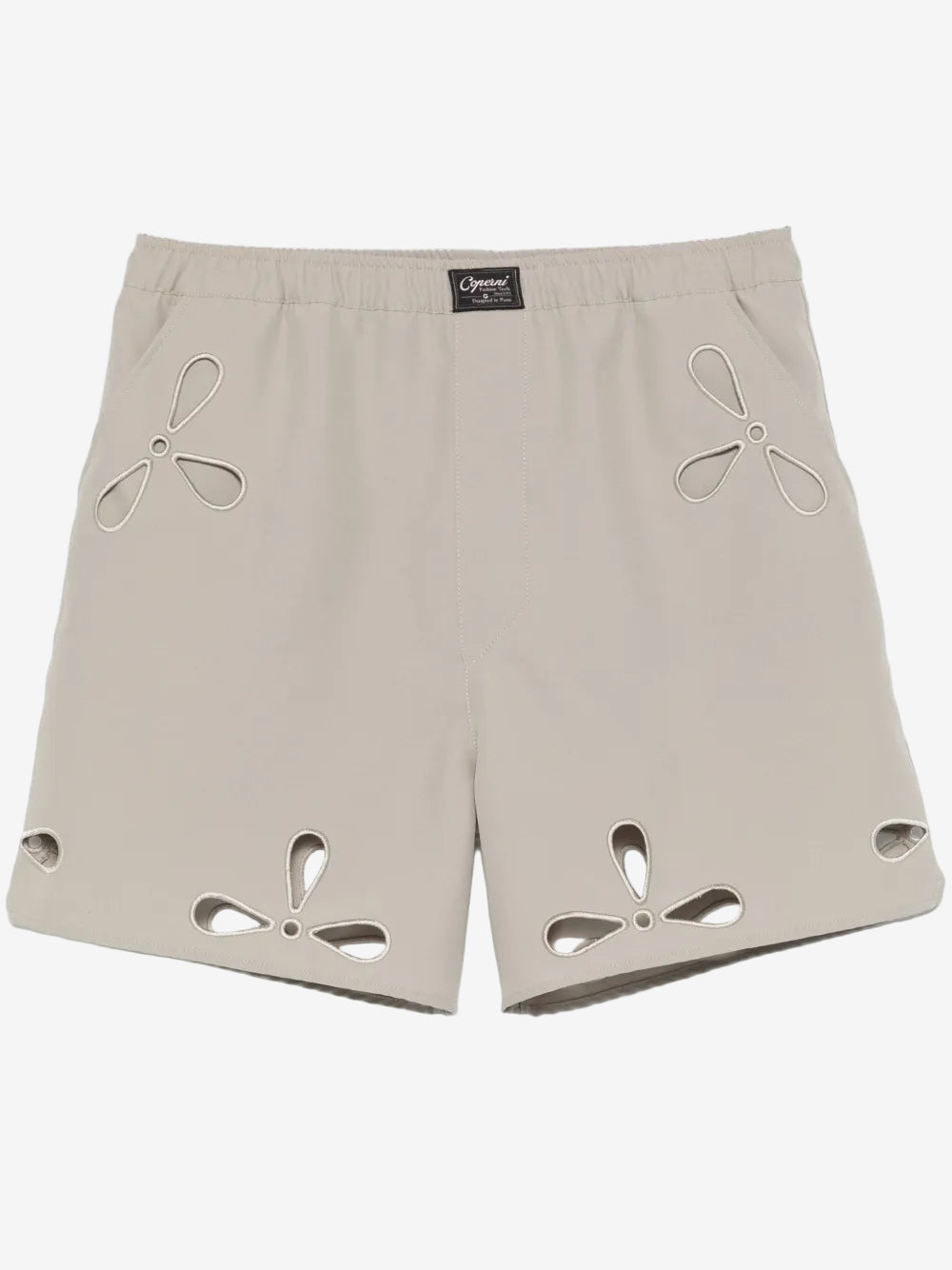 Beige shorts with cut-out designs on a white background