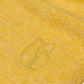 Close-up of a yellow textured fabric with a logo on a white background
