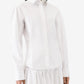 Person wearing a white shirt and white pants on a white background