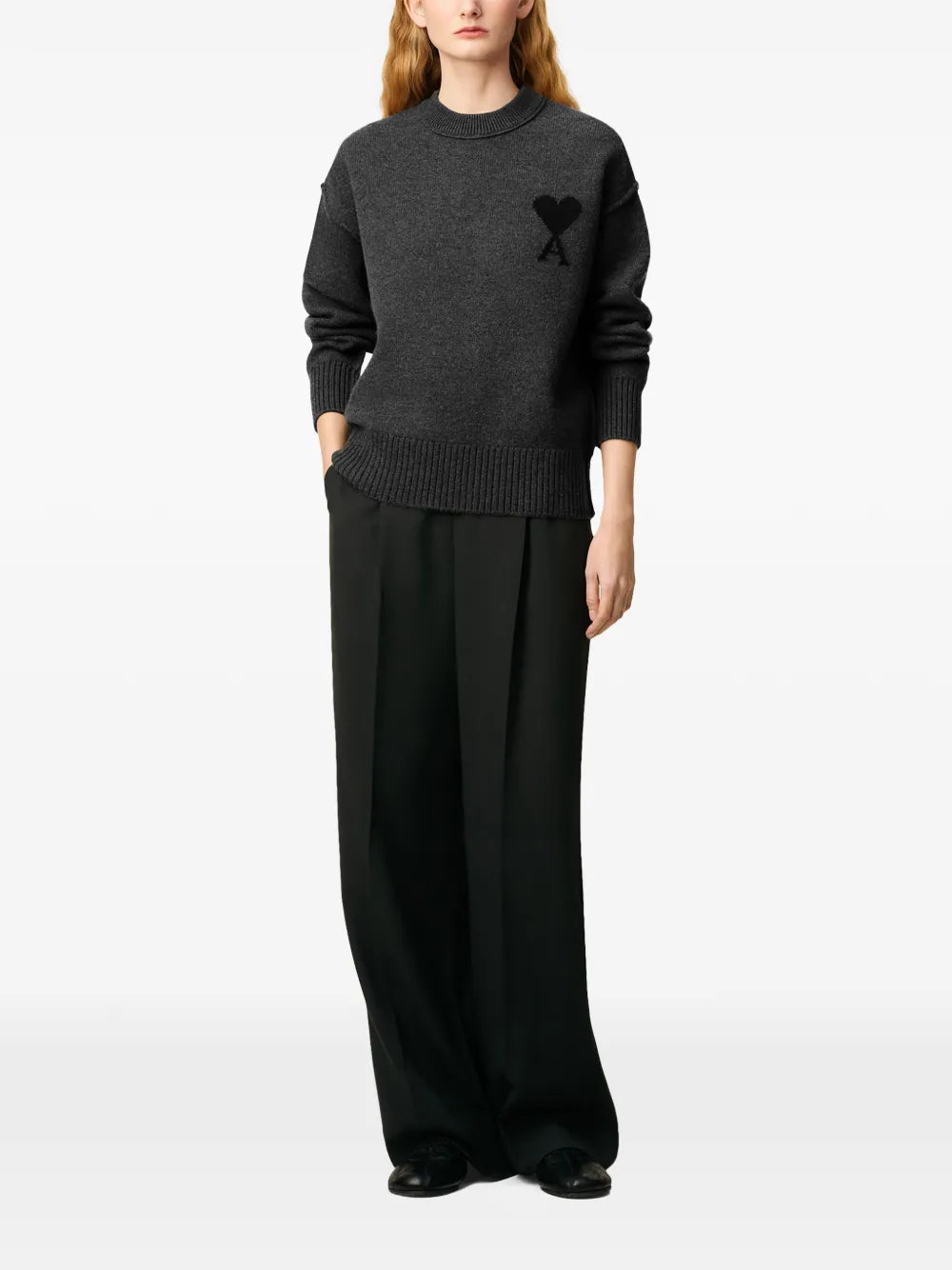 Gray sweater with a black heart and letter 'A' design on a beige background