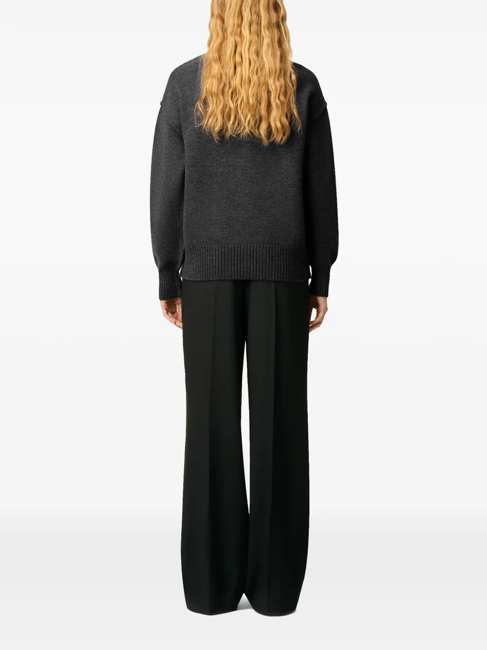 Gray sweater with a black heart and letter 'A' design on a beige background