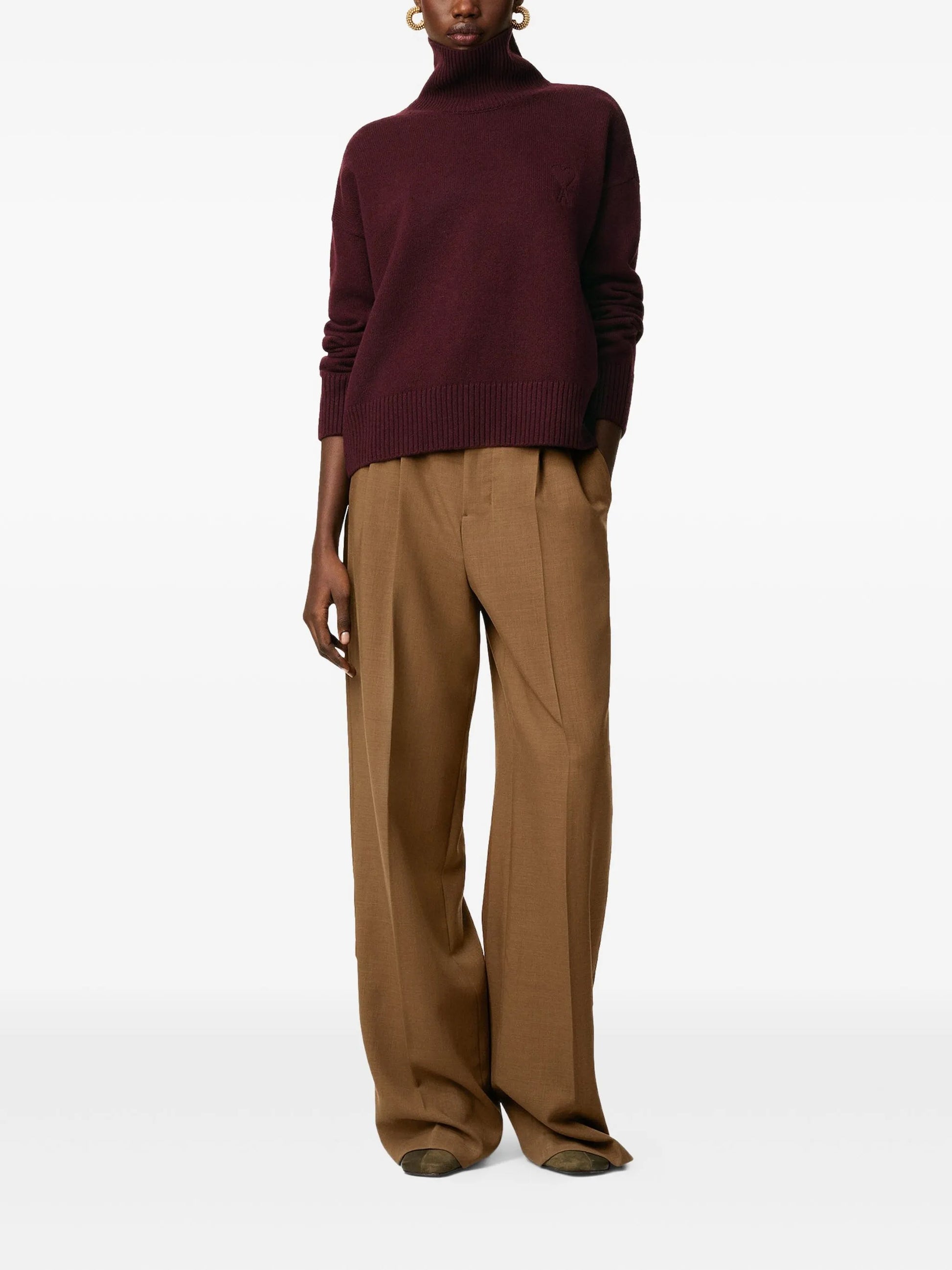 Maroon turtleneck sweater on a beige background