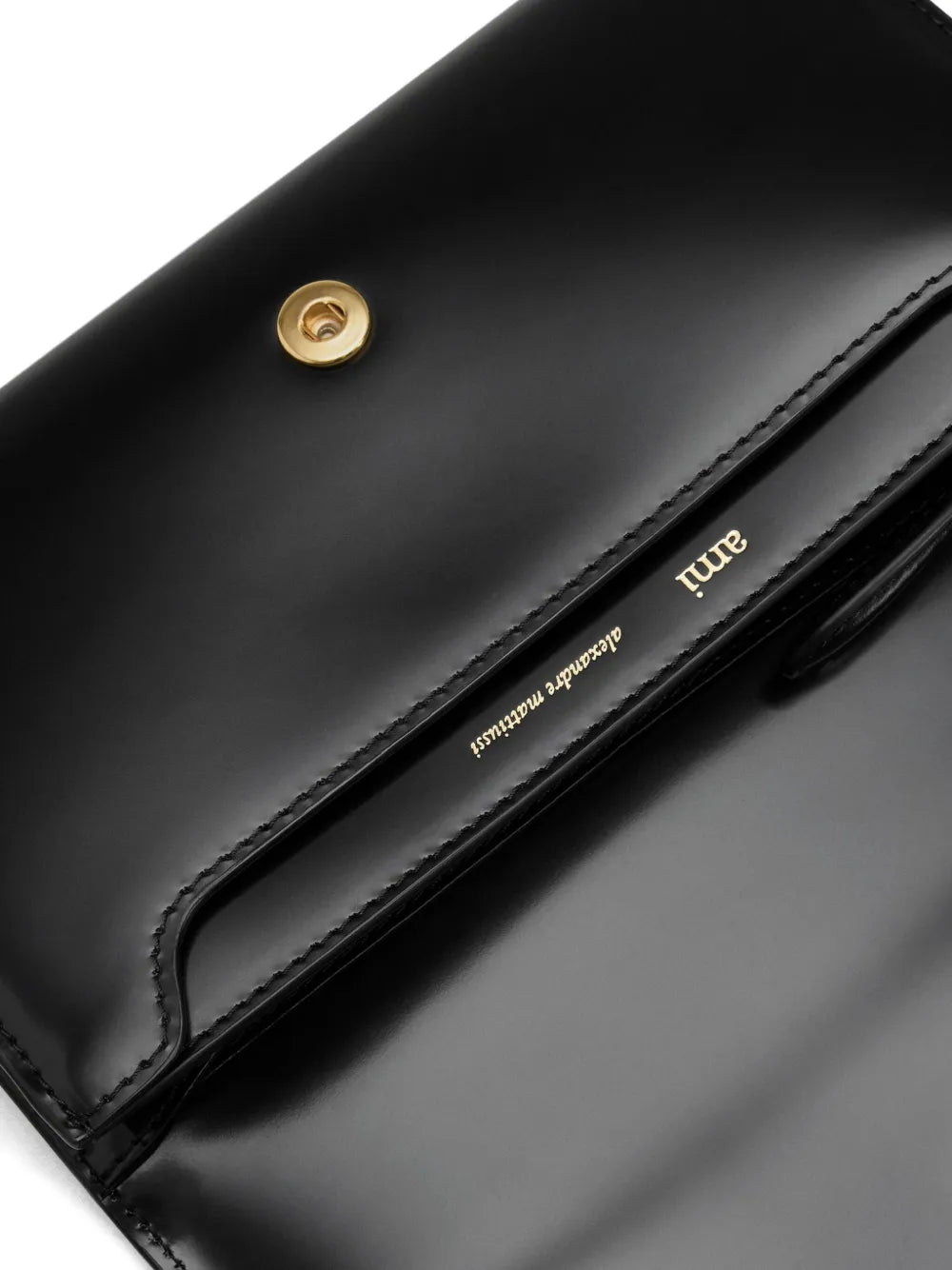 Black wallet with a gold emblem on a white background