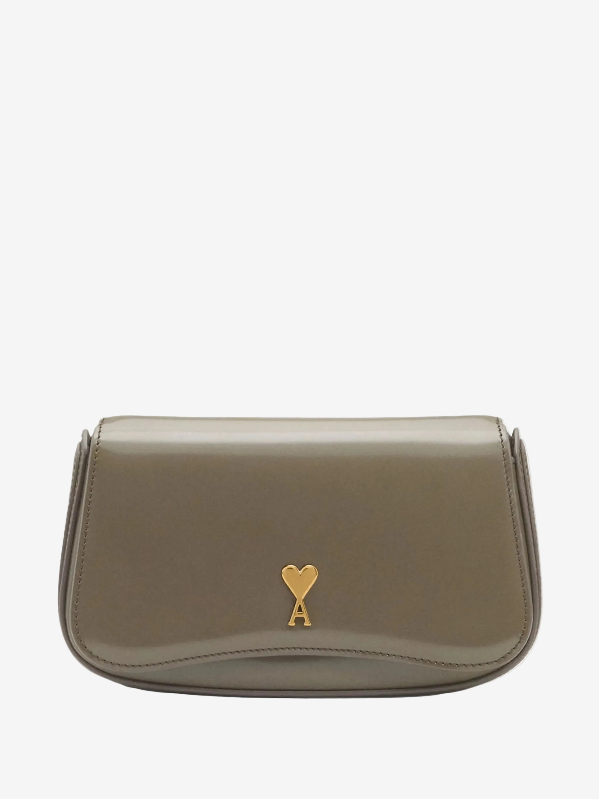 Green handbag with a gold heart emblem on a light beige background ami paris