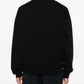 Black varsity jacket with a logo on the chest against a white background