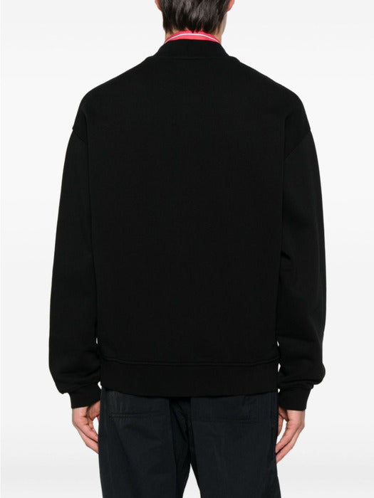 Black varsity jacket with a logo on the chest against a white background